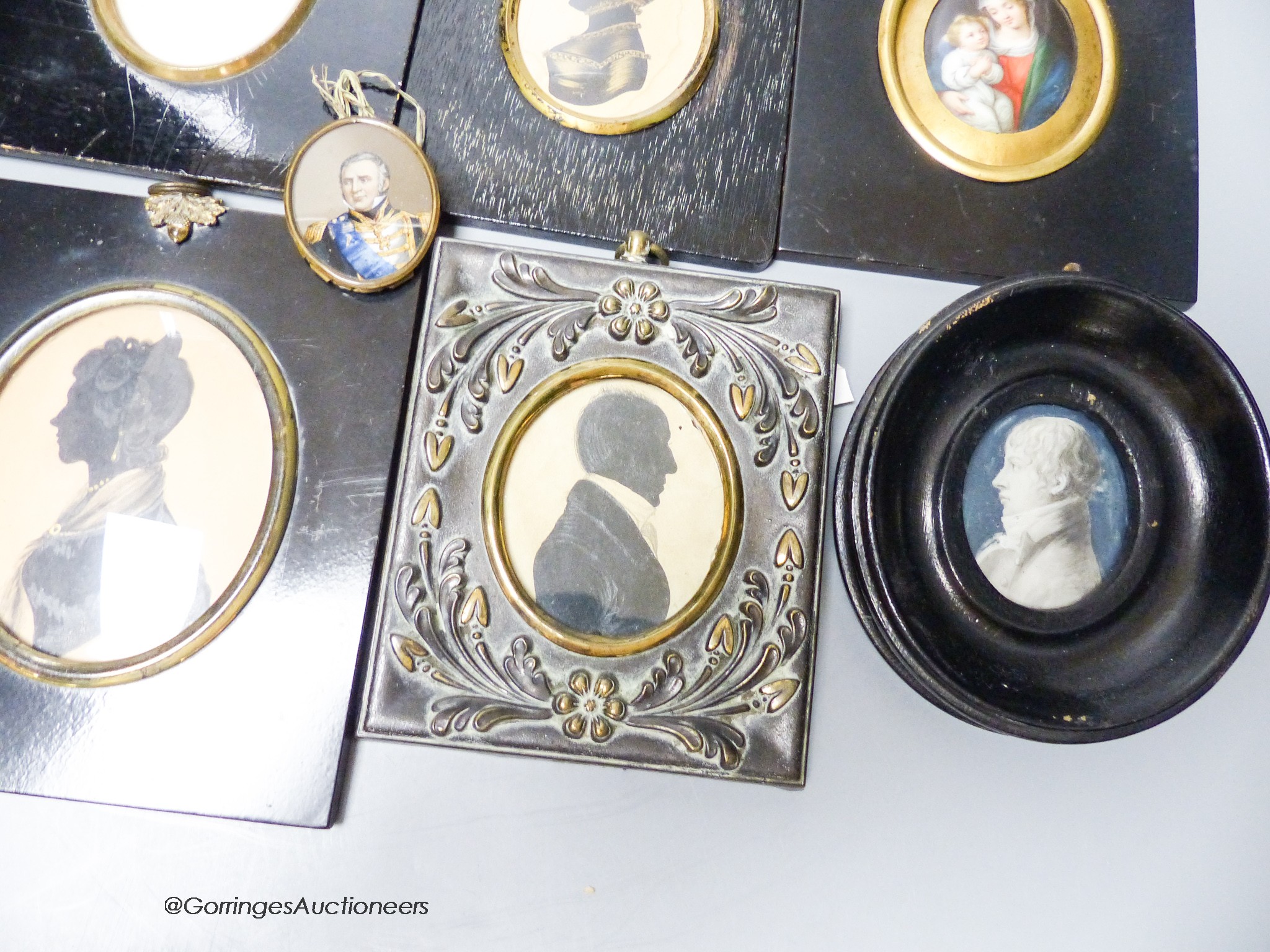 A 19th century portrait miniature, Madonna and child, together with five assorted silhouette portraits and two portraits (8)